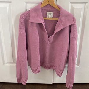 Abercrombie and Fitch notch-neck polo sweater in pink.